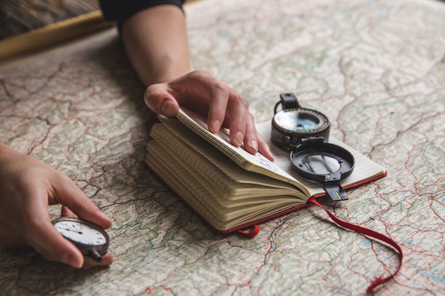 Person with compass, map and a plan of where to go next.